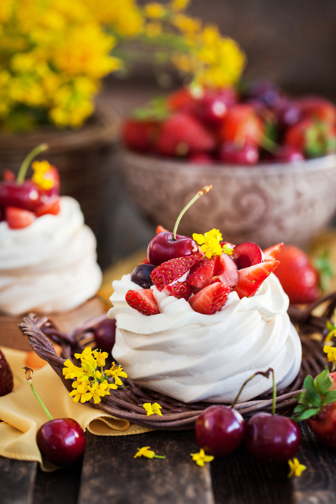 pavlova with strawberry whipped cream and cherries